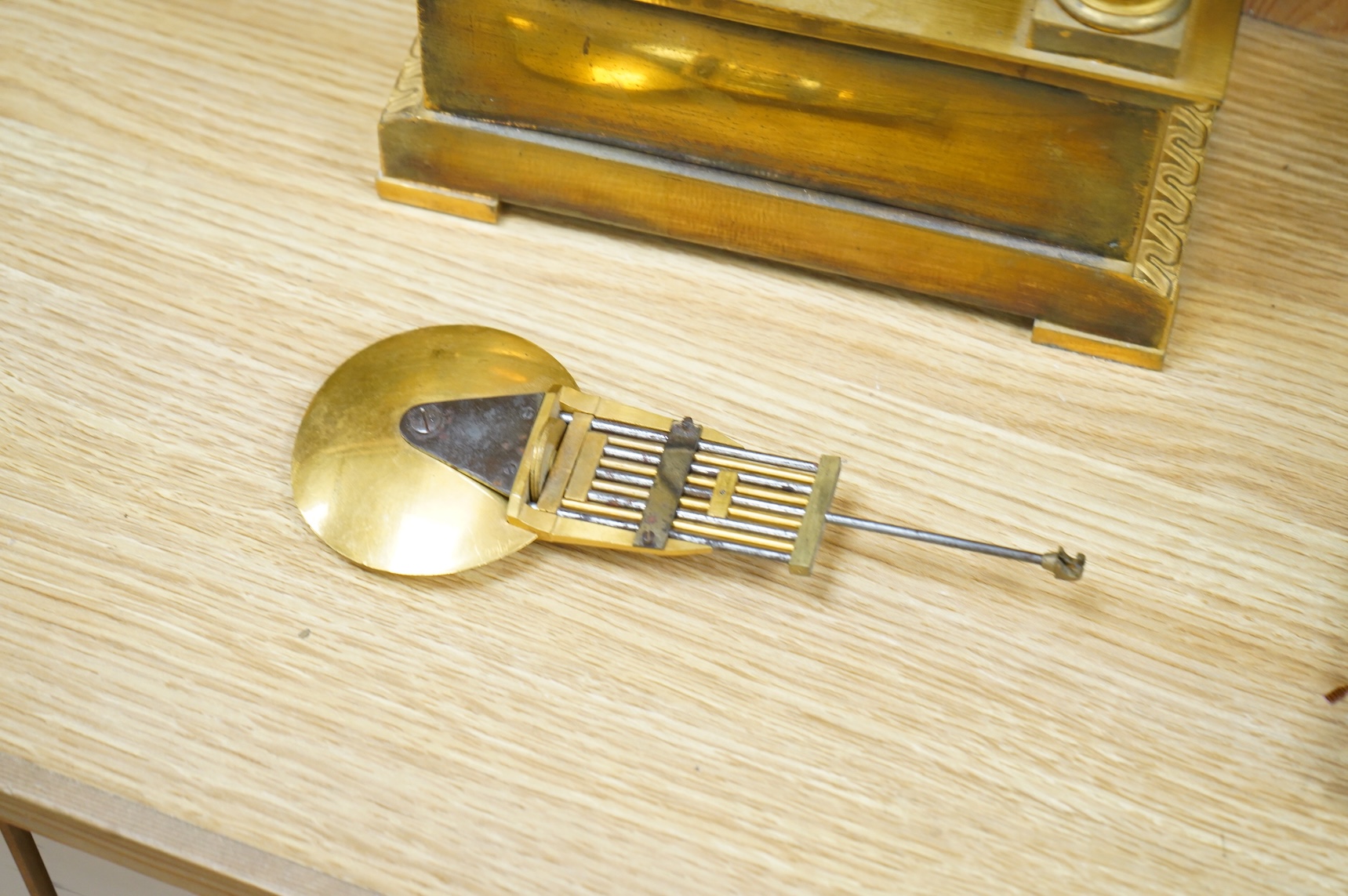 A 19th century French gilt brass eight day portico clock with pendulum, 38cm